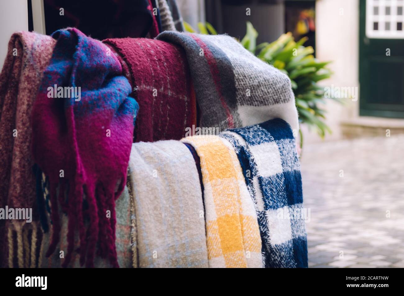 many traditional portuguese wool scarves in a touristic town alley Stock Photo