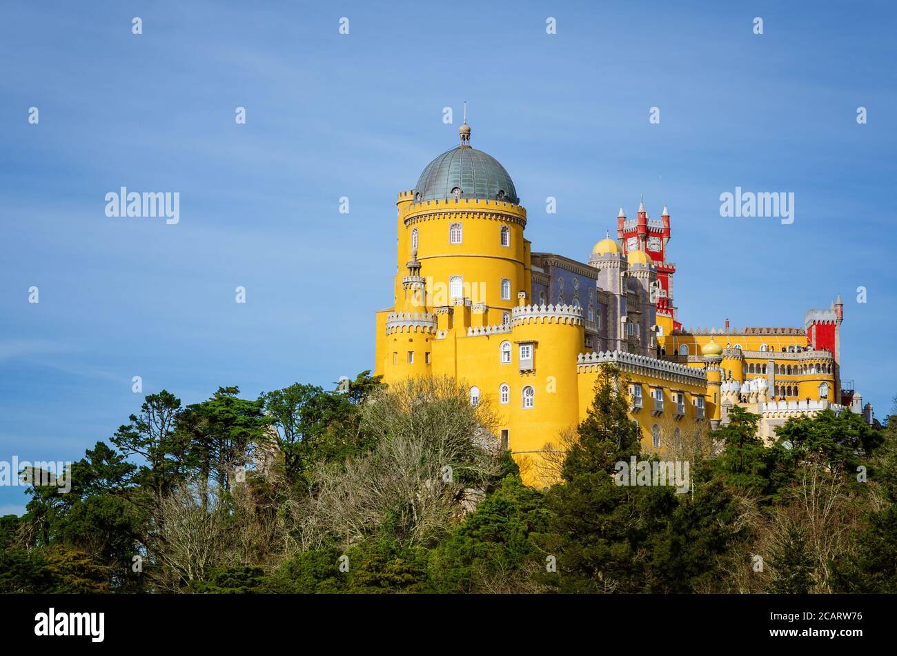 Sintra, Portugal - February 4, 2019: Far distant exterior view of the Pena Palace, famous colorful castle from the romantic age in Sintra, Portugal, o Stock Photo