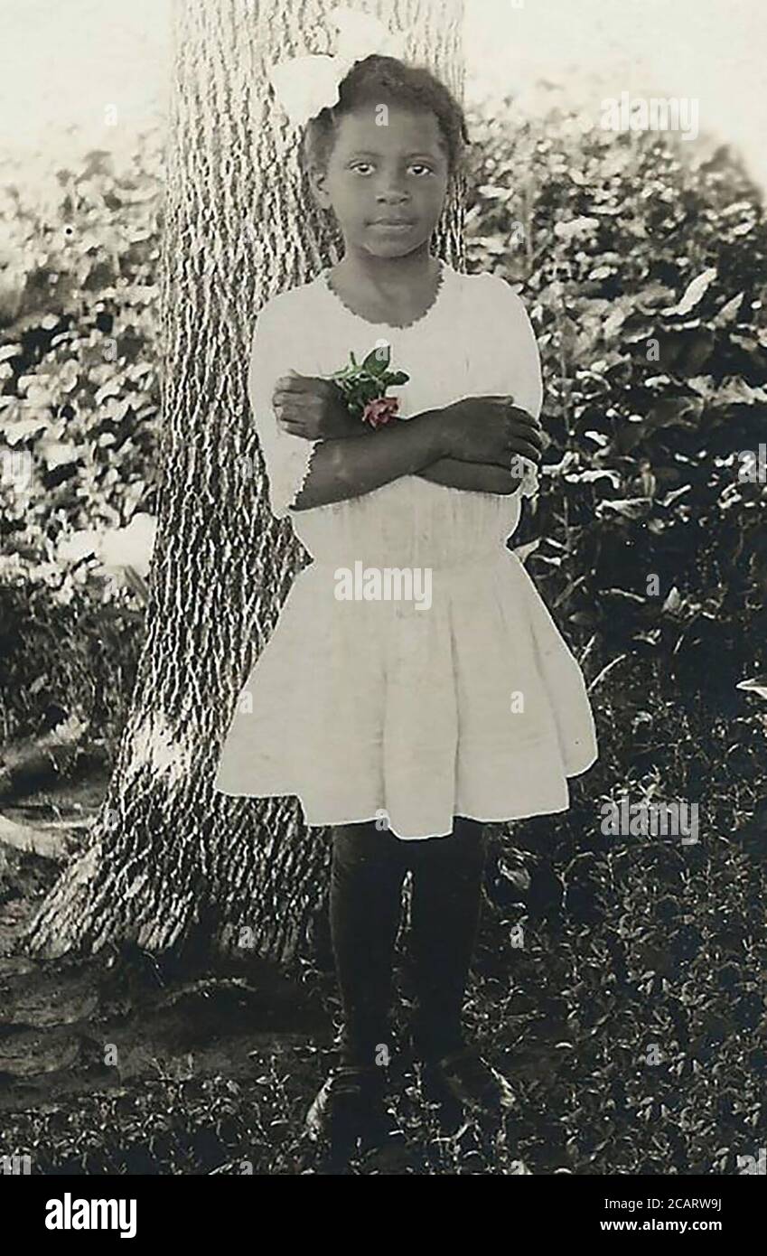 A pretty African American girl with rose and big bow Stock Photo