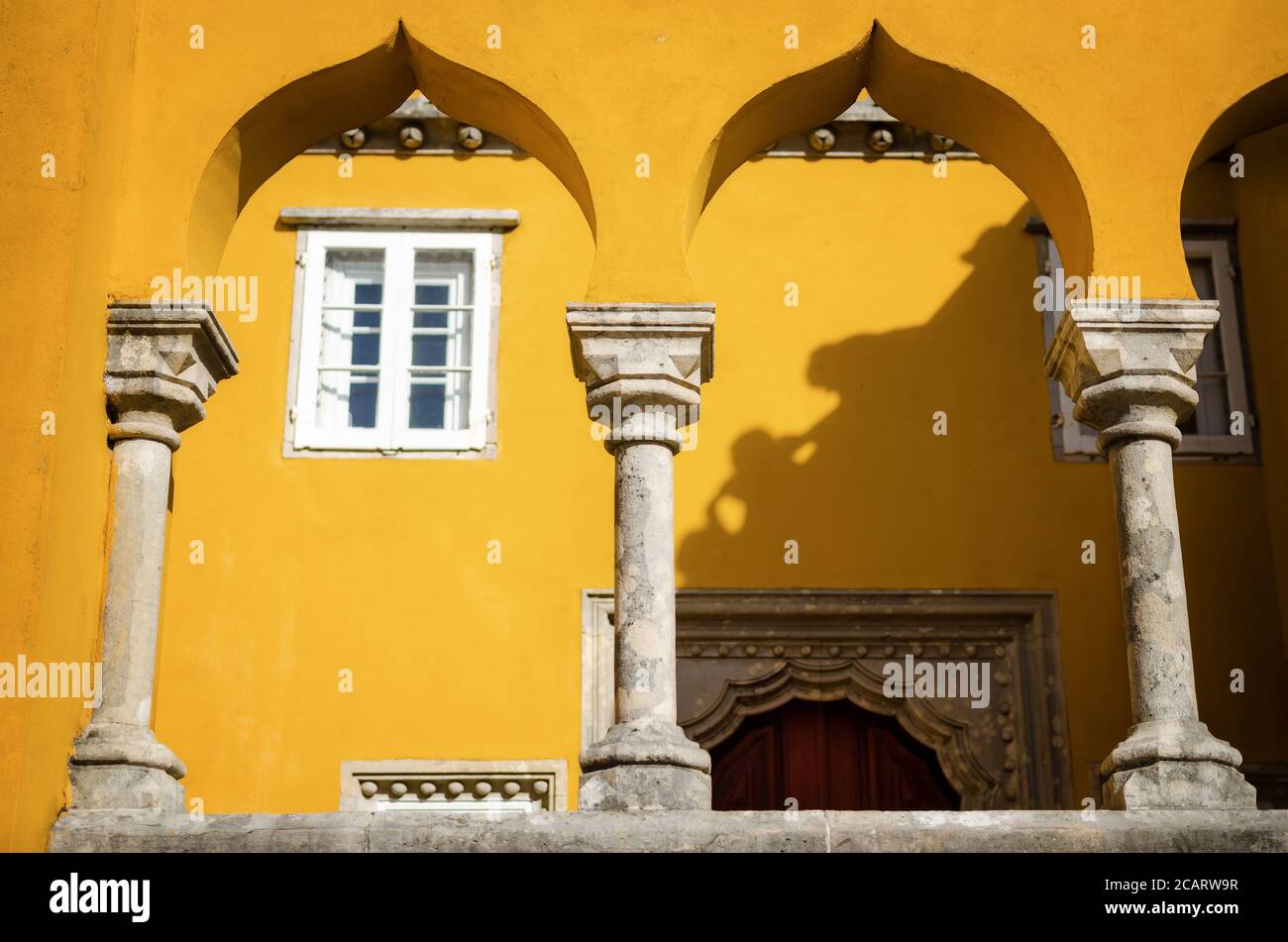 Sintra, Portugal - February 4, 2019: Exterior view of the Pena Palace, famous colorful castle in Sintra, Portugal, on february 4, 2019. Detail of the Stock Photo