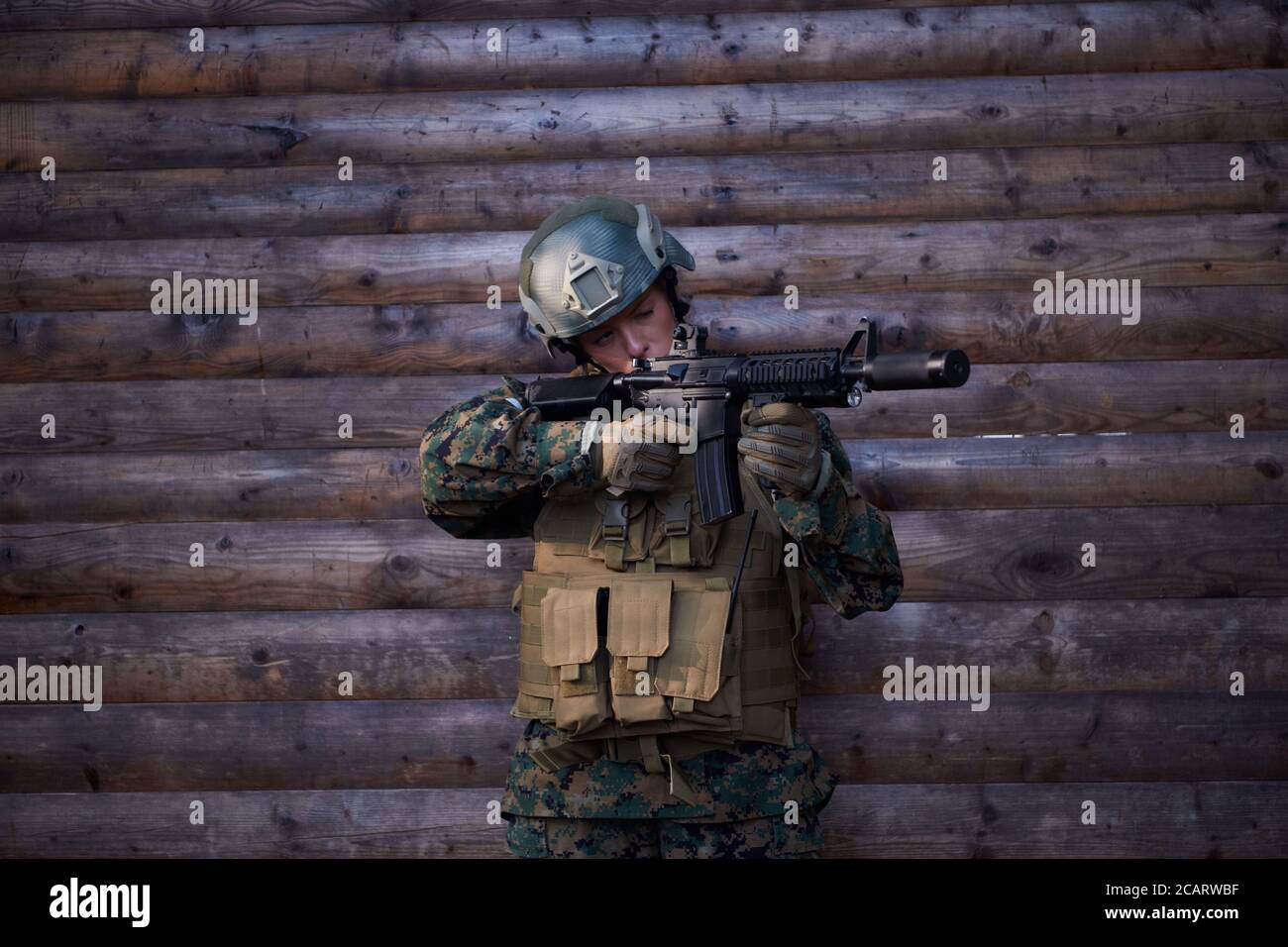 woman soldier ready for battle wearing protective military gear and