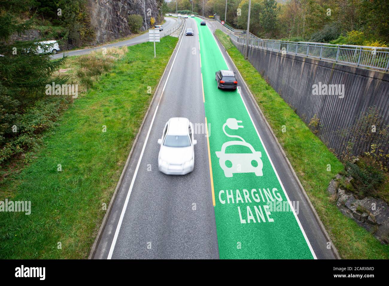 Road with lane for wireless charging of electric vehicles  Stock Photo
