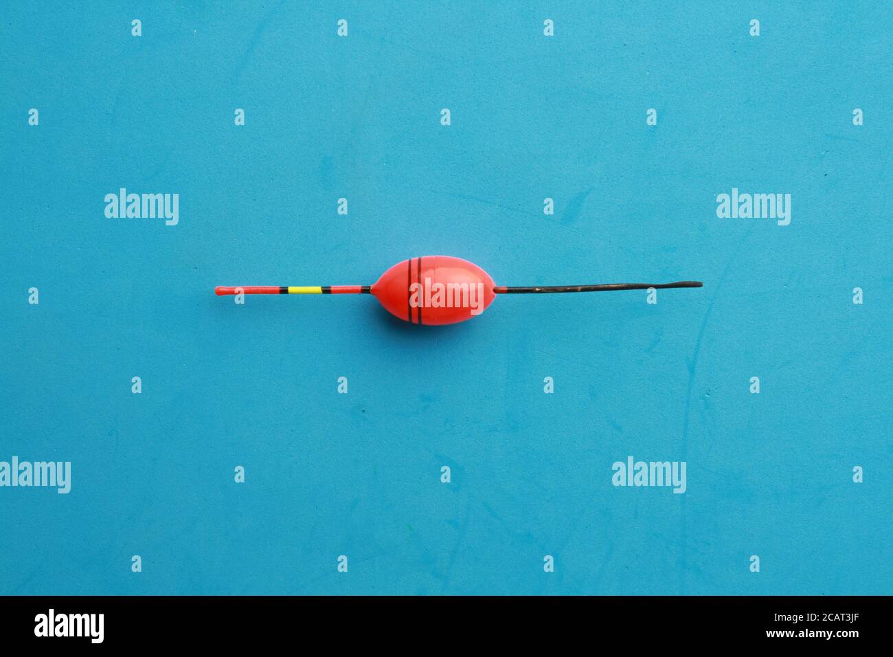 Closeup shot of a fishing lure on a blue background Stock Photo