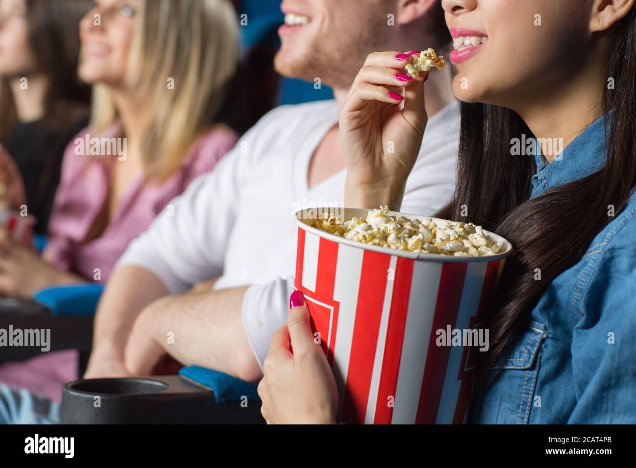 Me and my snack. Cropped closeup of a young woman eating popcorn