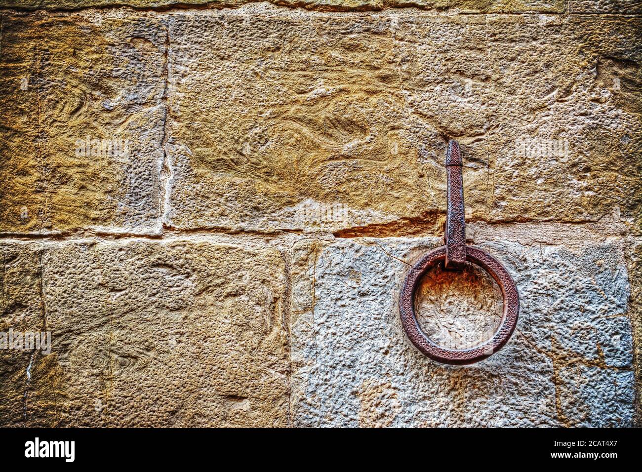 Ancient iron hoop hanging on stone wall Stock Photo Alamy