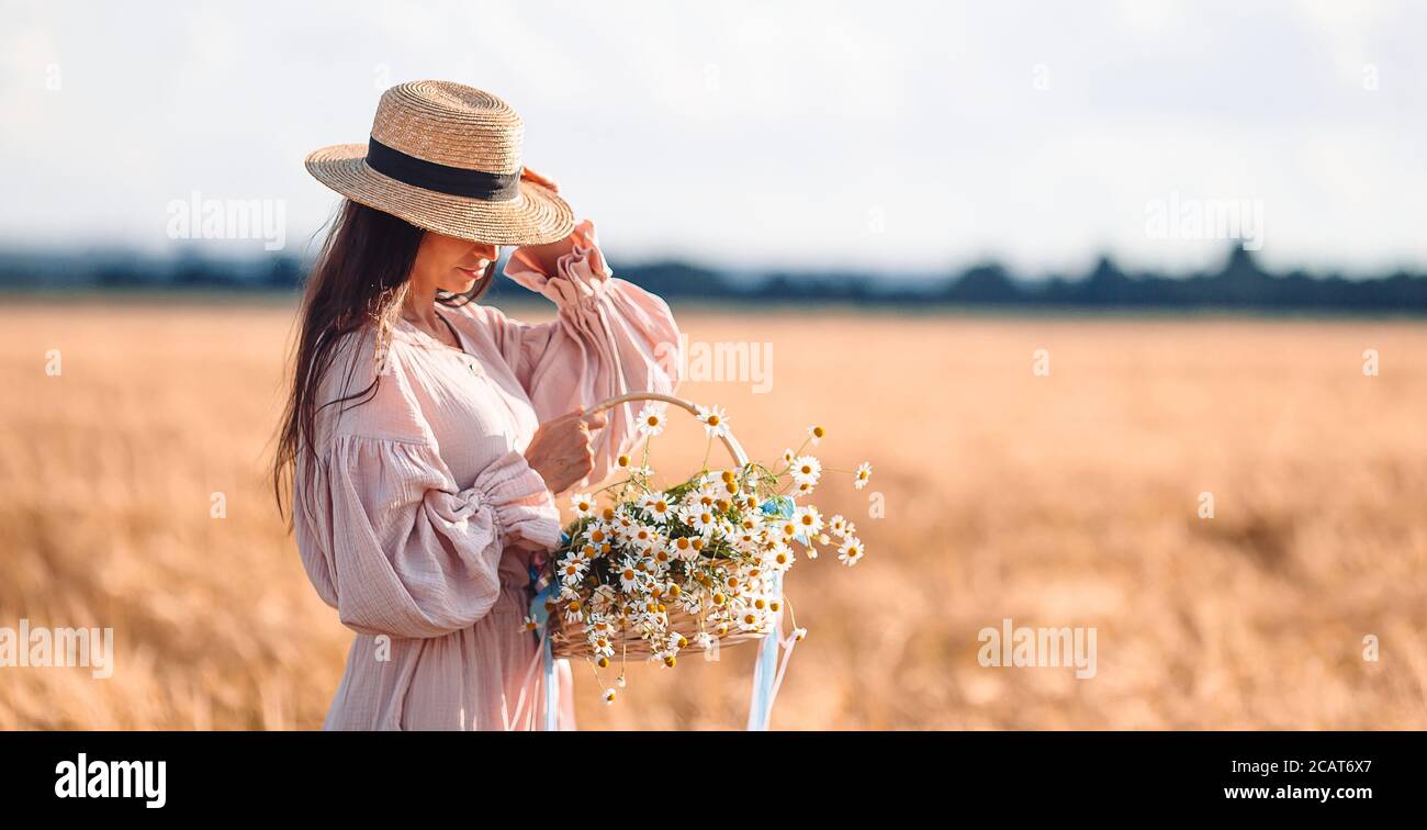 Beautiful girl in wheat field with ripe wheat in hands Stock Photo - Alamy
