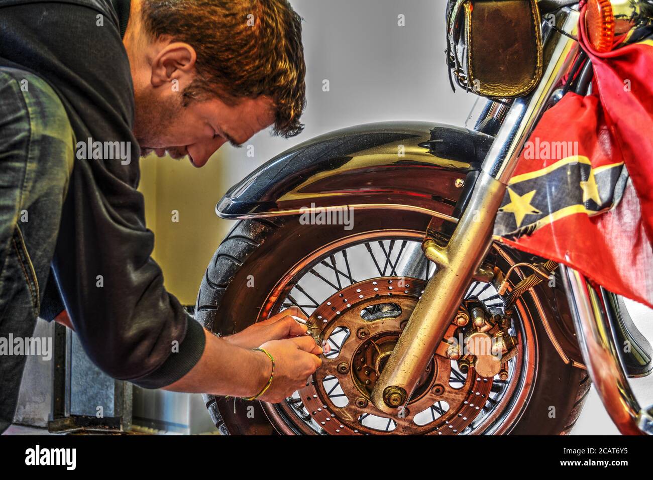 biker locking the disk brake of a classic motorcycle Stock Photo Alamy