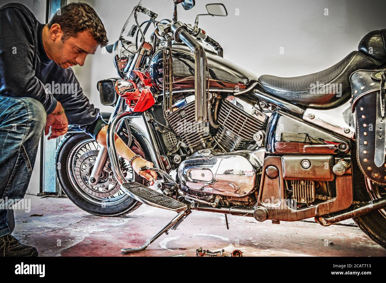 man repairing a classic motorcycle Stock Photo - Alamy