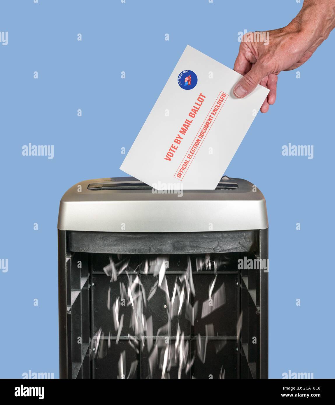 Vote by mail or absentee ballot being shredded in office paper shredder as illustration of voting fraud or lost votes in Presidential election Stock Photo