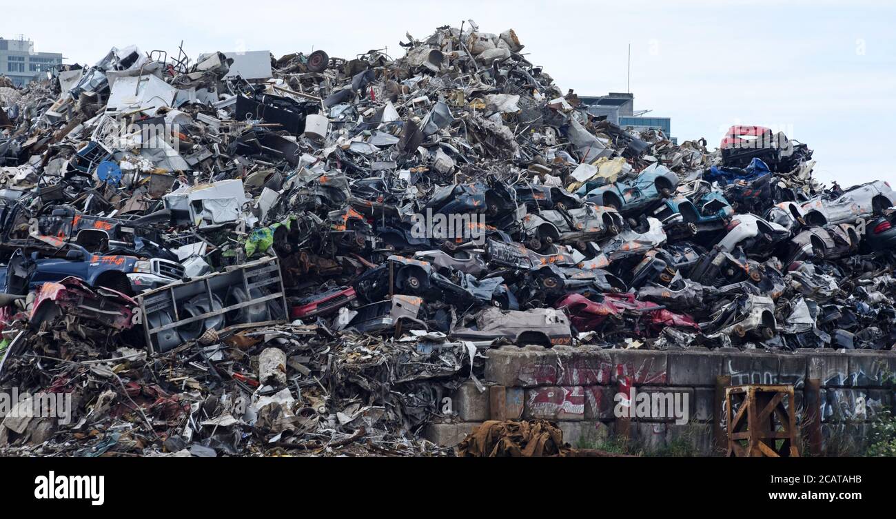 A pile of crushed vehicles and other metal sit in a huge pile at a ...