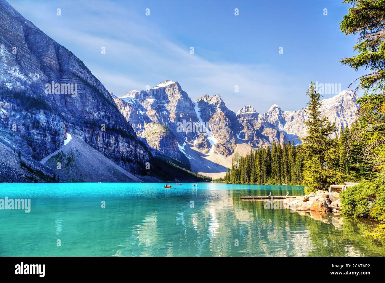 Unidentifiable visitors canoeing their boats on turquoise-colored ...