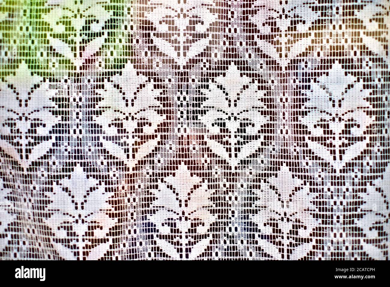 Decorative net curtain, translucent sheer floral pattern fabric. Stock Photo