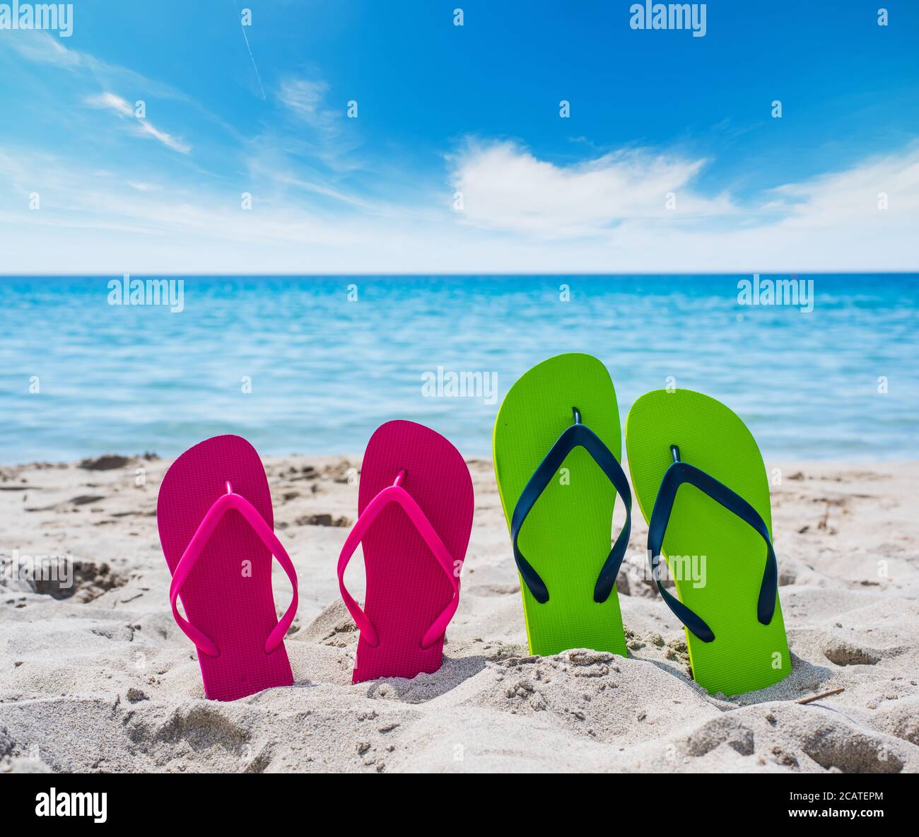 colorful flip flops on the sand Stock Photo - Alamy