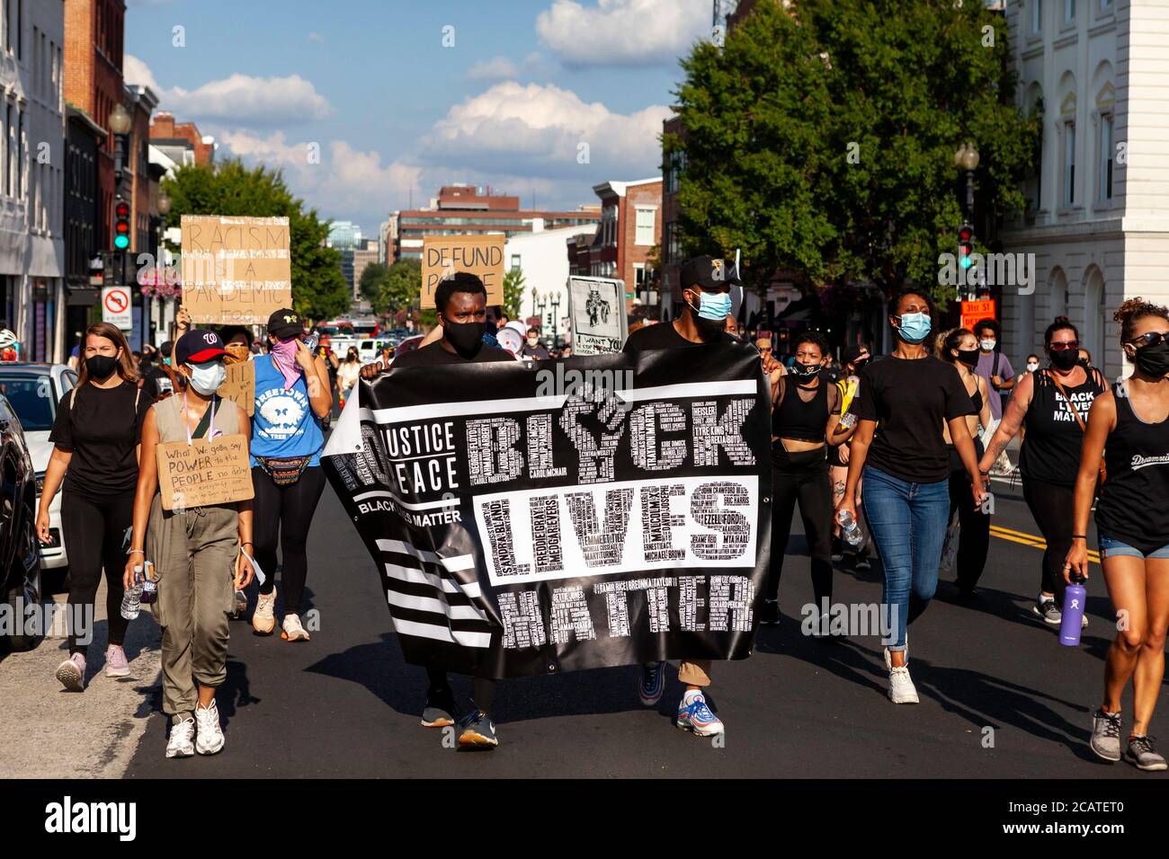 Washington, DC, USA. 8th Aug, 2020. Pictured: Protesters at the Black Lives Matter/Defund the Police March walk down M Street NW in Georgetown. The banner calls for justice and has the names of hundreds of victims killed by police.. Credit: Allison C Bailey/Alamy Credit: Allison Bailey/Alamy Live News Stock Photo