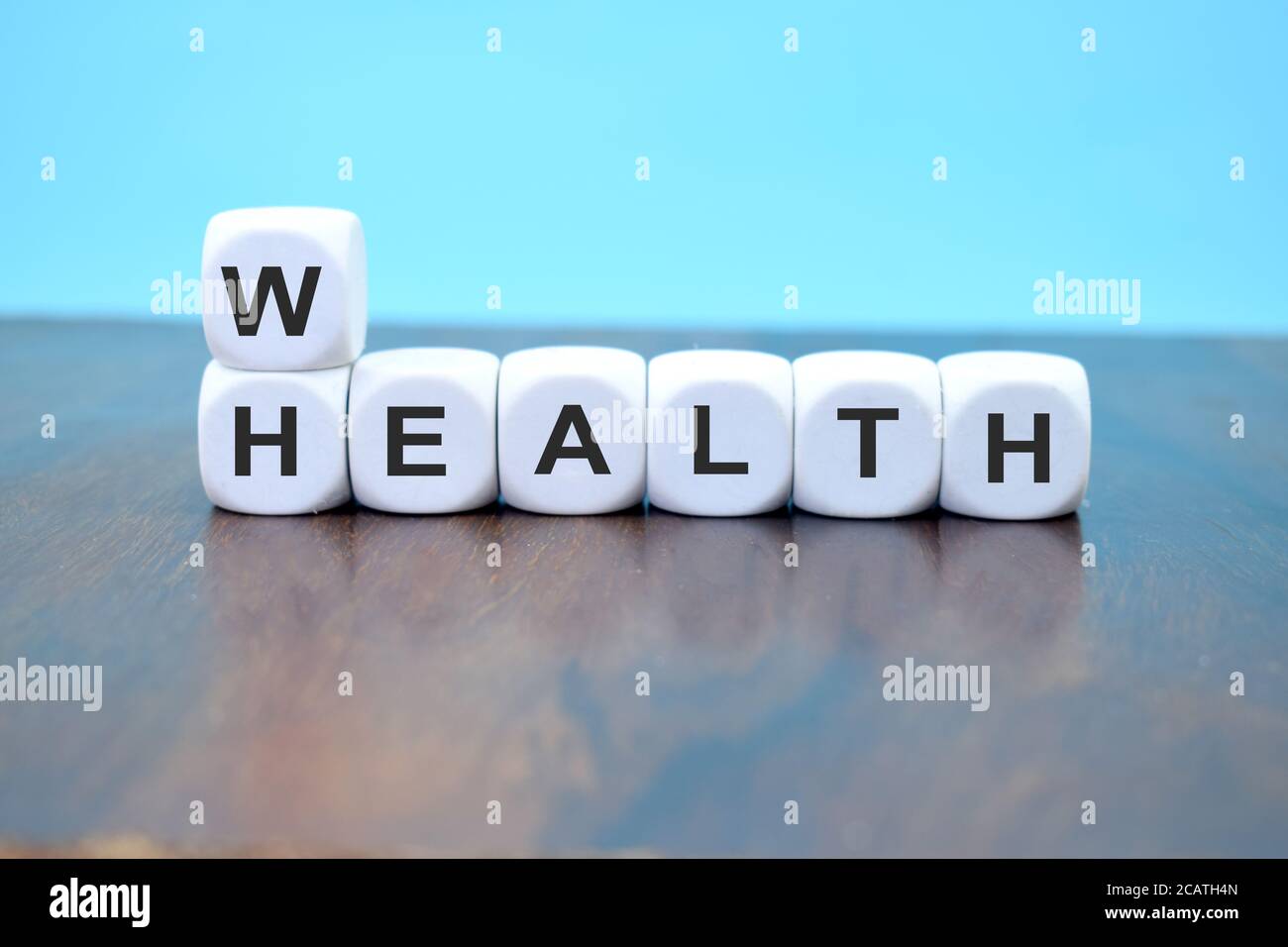 cubes showing the word health and wealth at the same time symbolizing to keep the balance Stock Photo