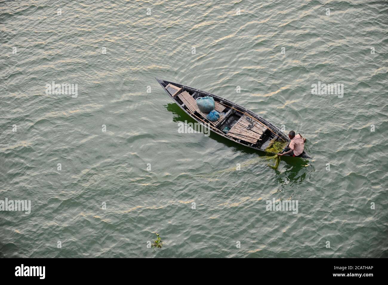 A fisherman seen trying to catch some fish. In the delta of rivers Ganga (Padma), Brahmaputra and Meghna people live on the water. Stock Photo