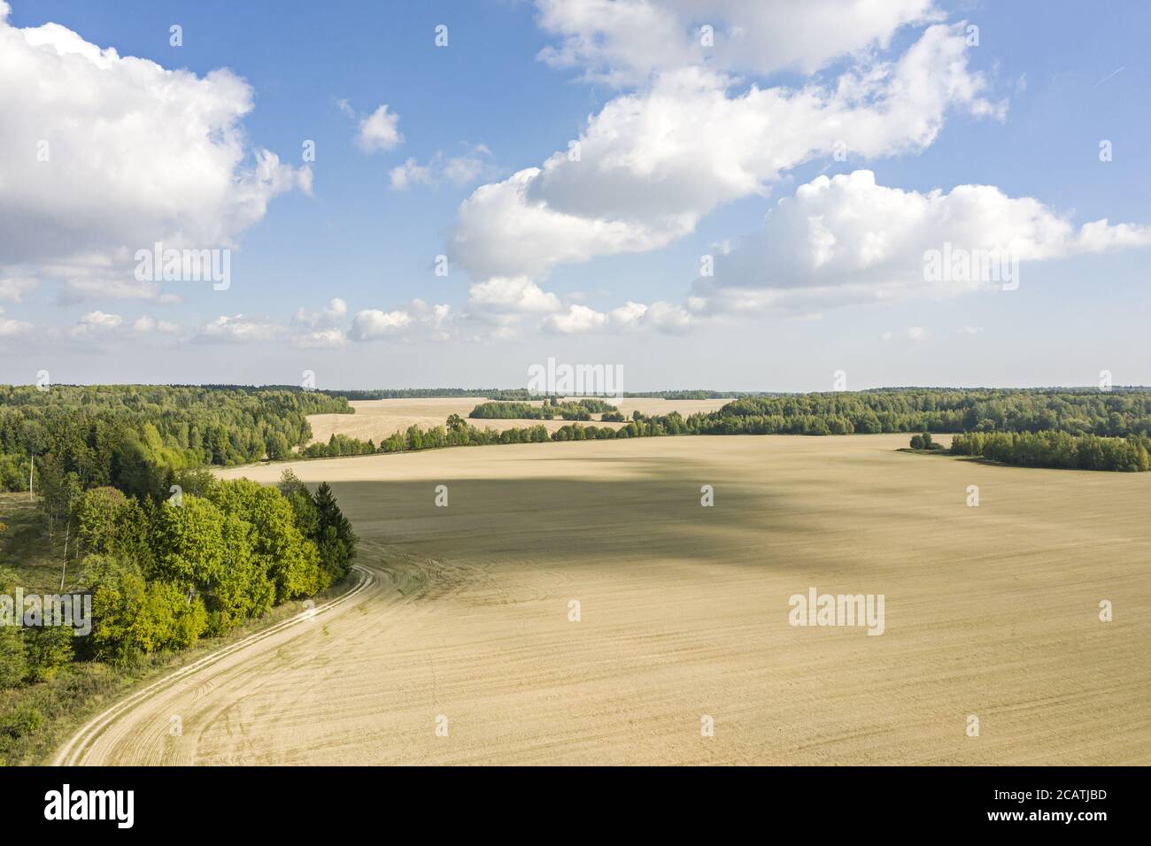rural landscape with agricultural fields under blue sky and white ...