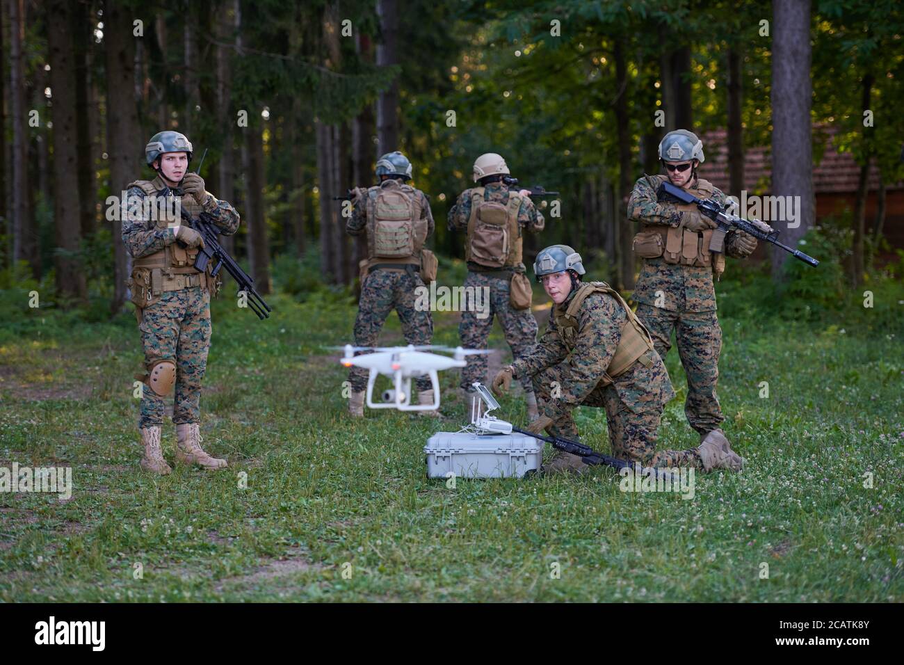 Modern Warfare Soldiers Squad are Using Drone for Scouting and Surveillance During Military Operation in the Forest. Stock Photo