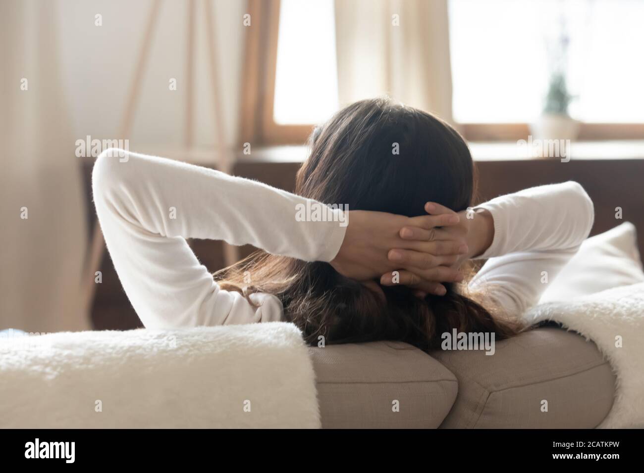 Mindful serene millennial girl sleeping napping on comfortable sofa