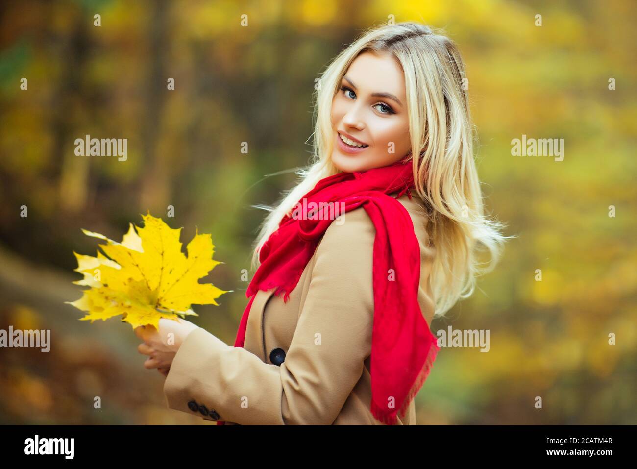 Young woman walking in an autumn leaf park Stock Photo - Alamy