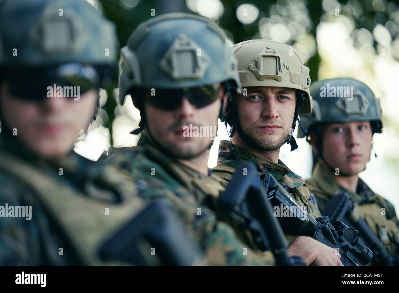 Soldier fighters standing together with guns. Group portrait of US army