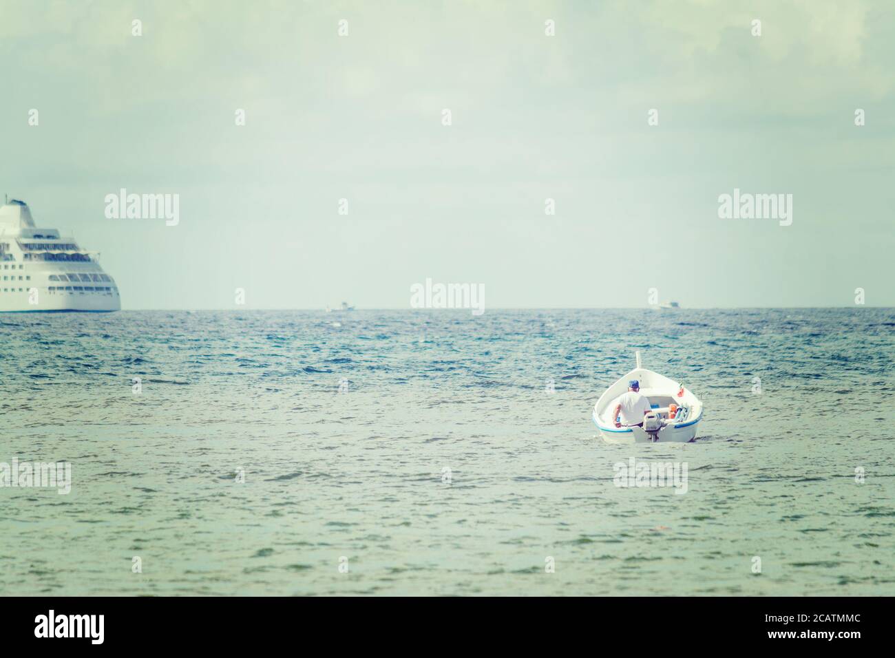old man in a small boat in the sea Stock Photo - Alamy