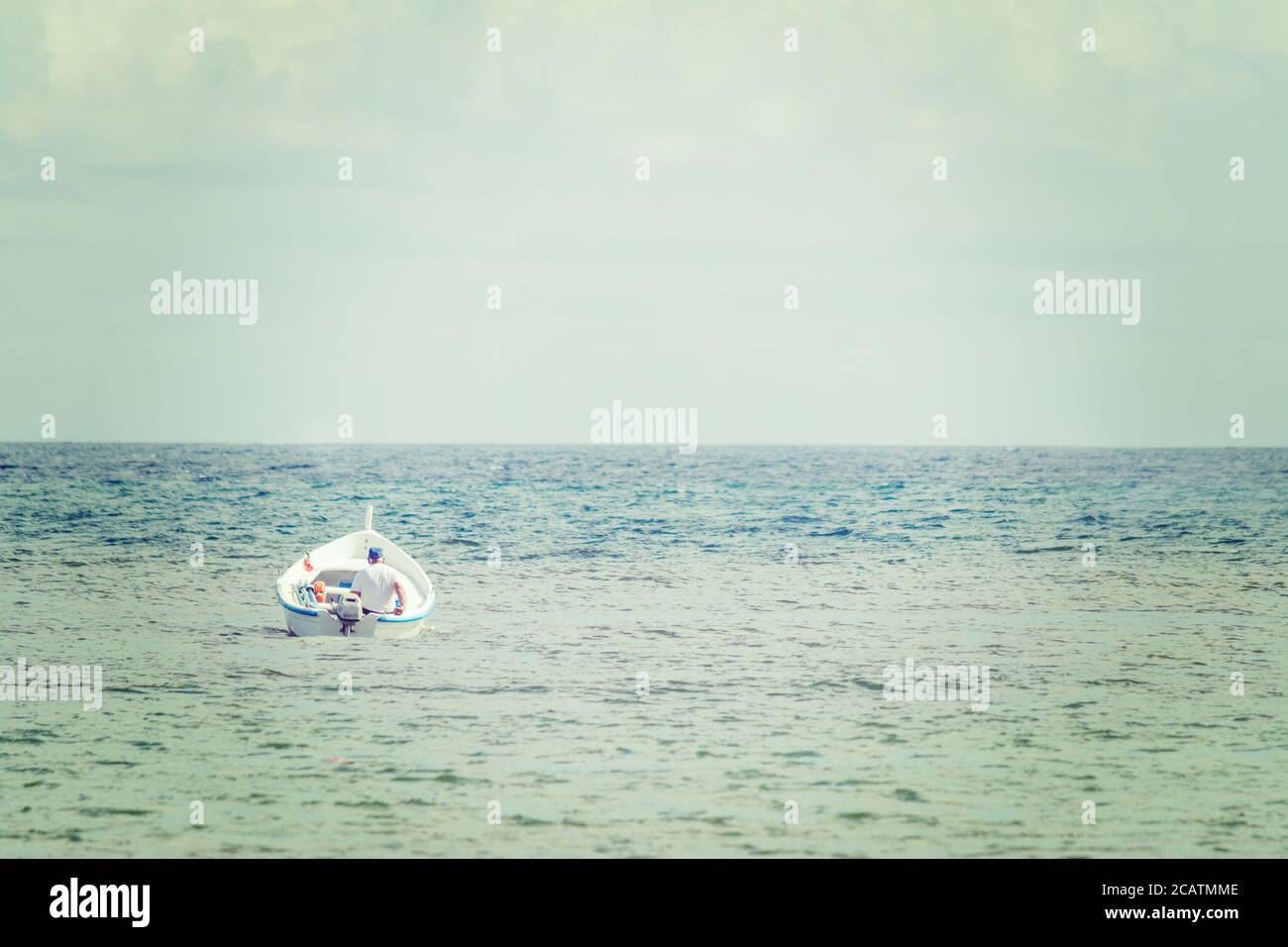old man in a small boat alone in the sea Stock Photo - Alamy