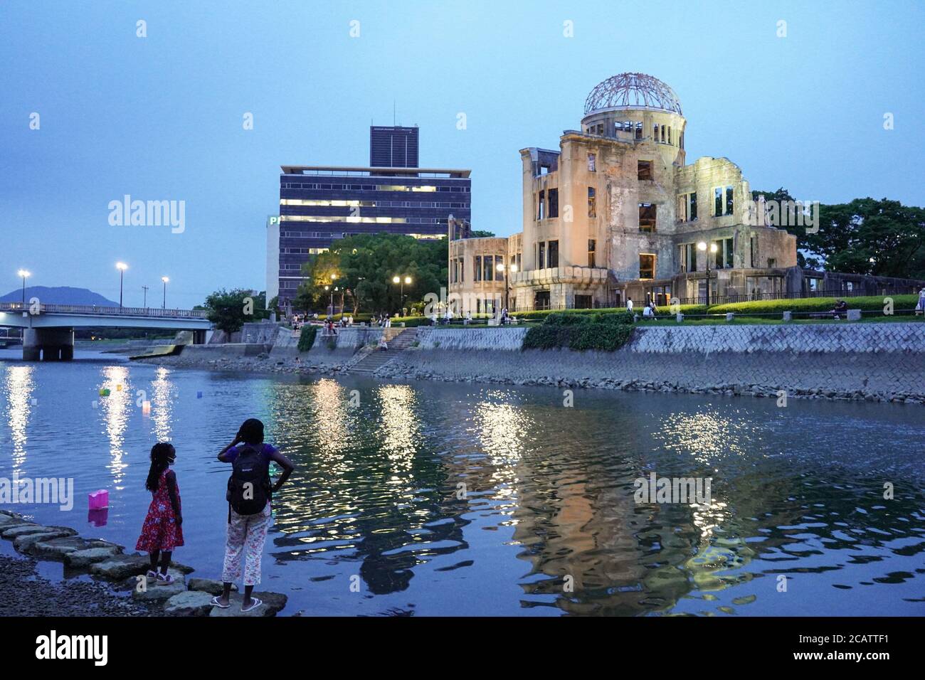 Hiroshima, Japan. 06th Aug, 2020. Visitors look at the scaled down lantern ceremony at the Atomic Bomb Dome along the Motoyasu River. Hiroshima will mark the 75th anniversary of the atomic bombing which killed about 150,000 people and destroyed the entire city for the first bombing with a nuclear weapon in war. Credit: SOPA Images Limited/Alamy Live News Stock Photo