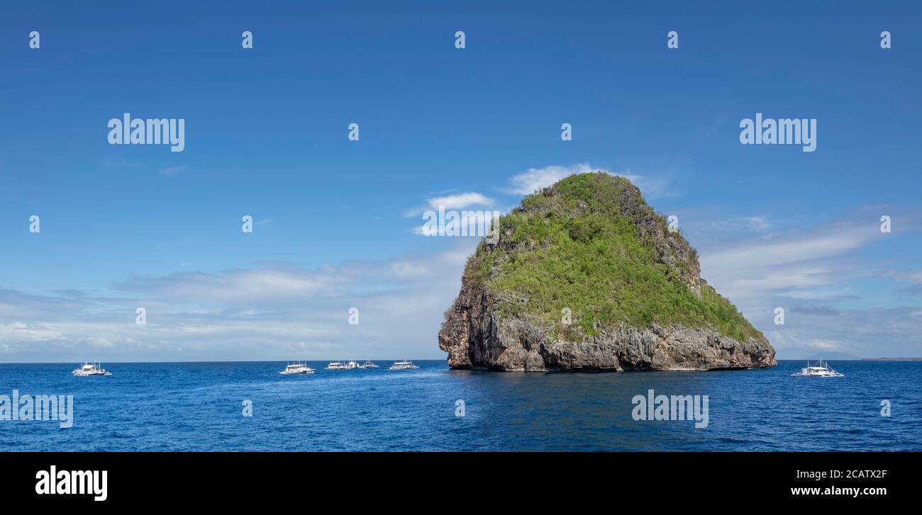 Three images were combined for this panorama view of the island of Gato, Bohol Sea, Philippines, Southeast Asia. The boats are from nearby Malapascua Stock Photo