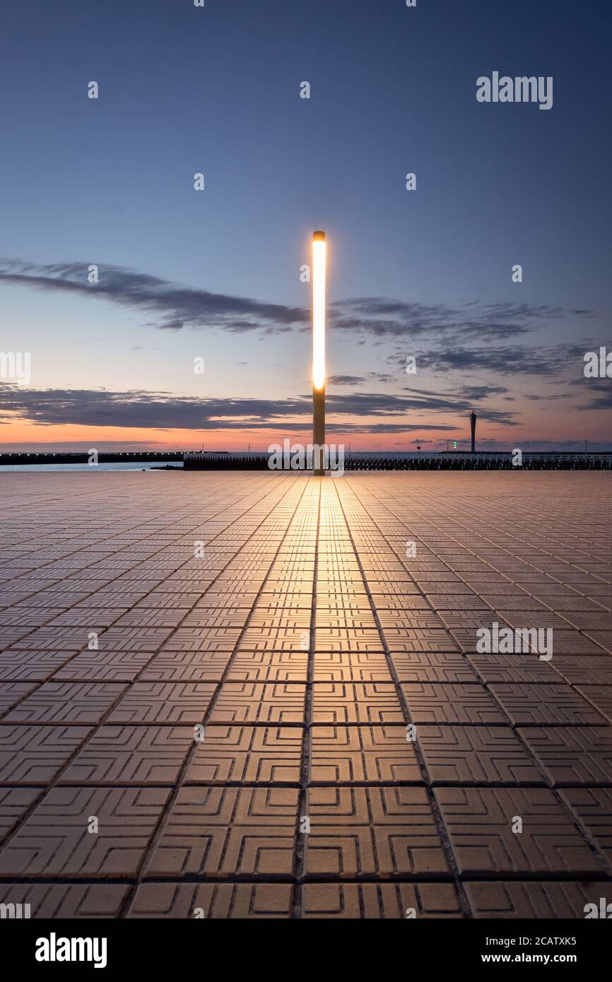 Light pole near the beach of Ostend in Belgium against sunset sky. Stock Photo