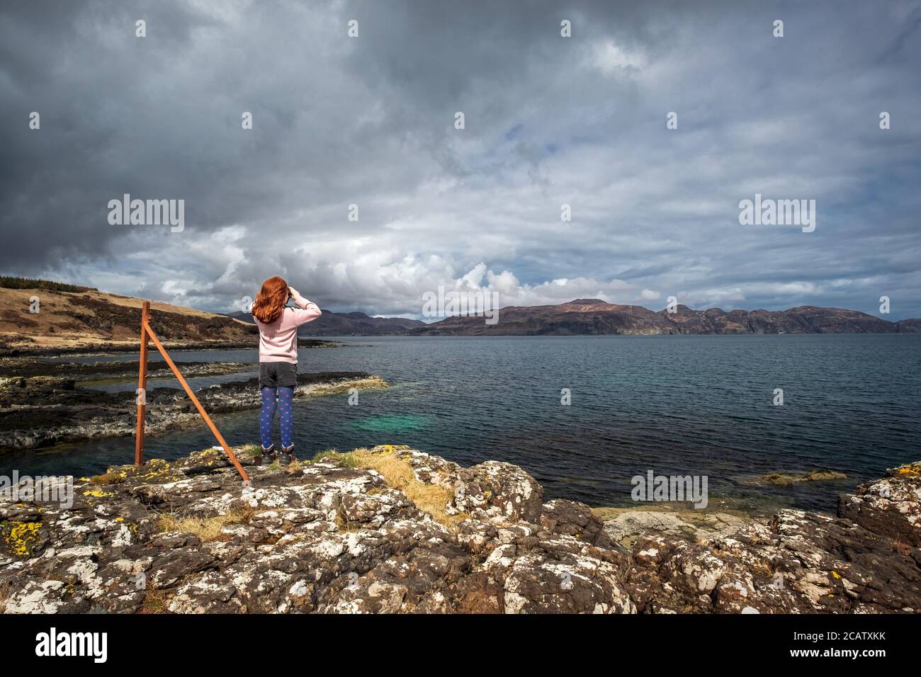 Girl with ginger hair against Scottish landscape on the Isle of Mull Stock Photo