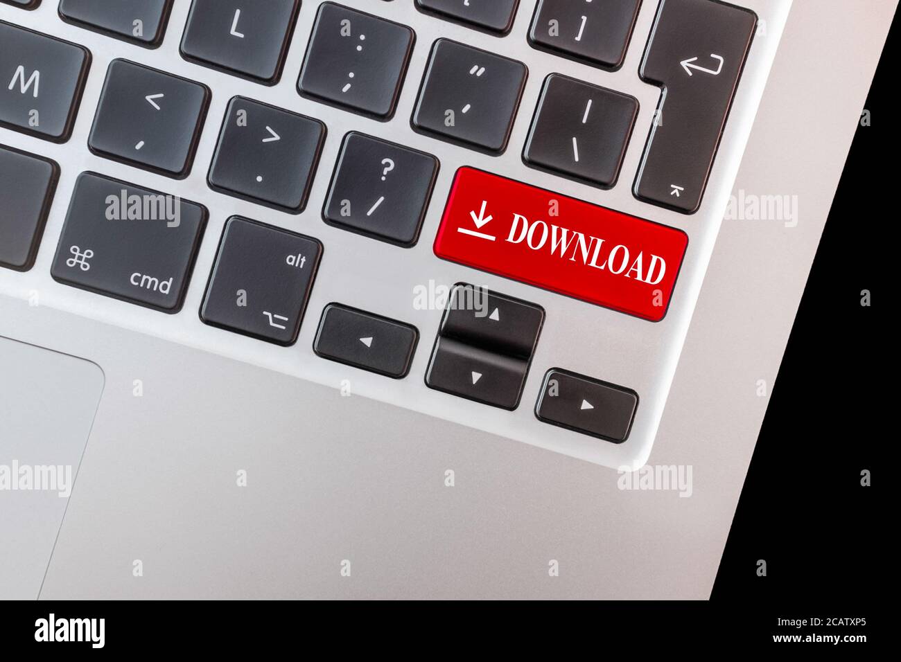 Closeup of a computer keyboard with a red download key. Stock Photo