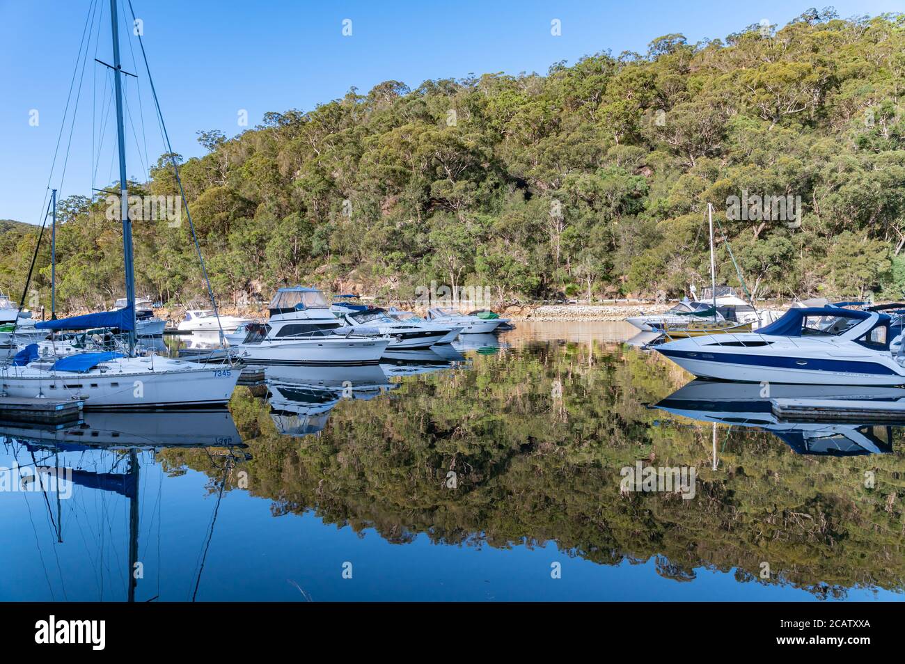 Boats and Yachts moored at D'Albora Marinas Akuna Bay on a sunny winter afternoon Stock Photo