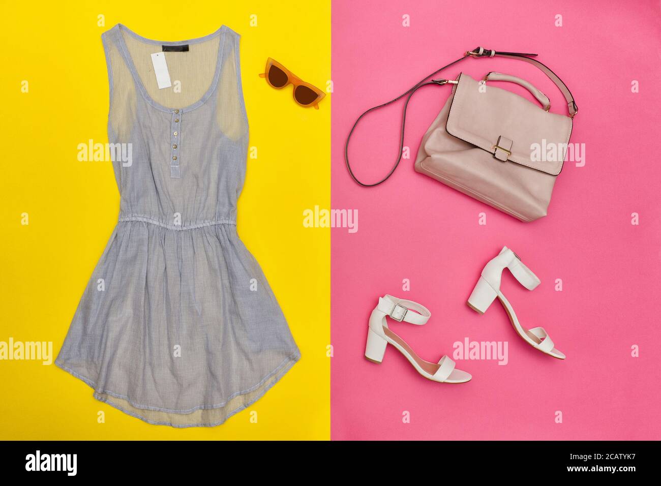 Blue dress, pink handbag, white shoes and rose-colored glasses. Bright pink  and yellow background, close-up Stock Photo - Alamy