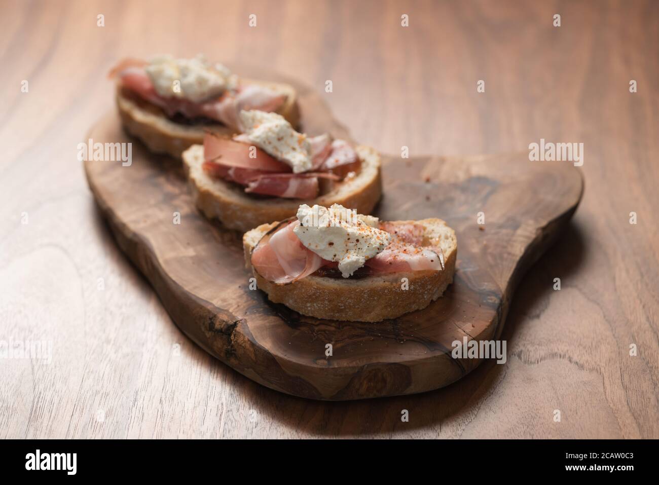Bruschetta with panchetta, ricotta and fig jam Stock Photo Alamy