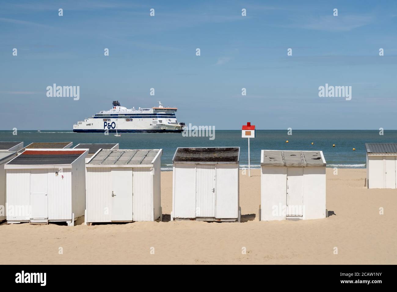 Massive ferry sailing in front of the beach of Calais. Stock Photo