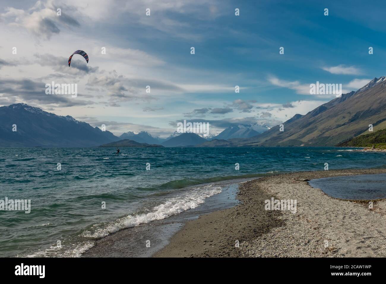 Kite surfer on Lake Wakatipu in New Zealand between Queenstown and Glenorchy. Stock Photo