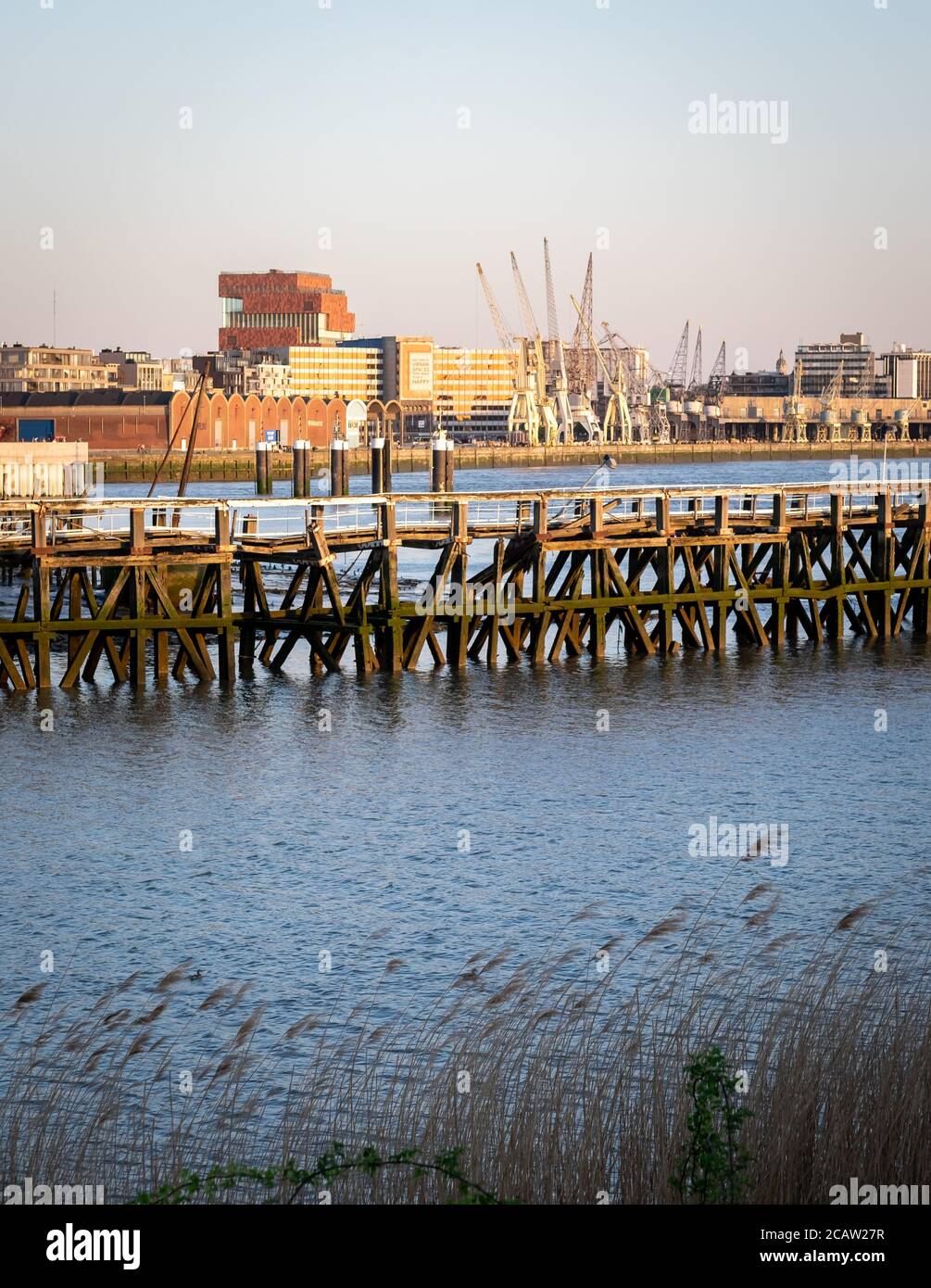 Old wooden pier in front of the Northern part of the city of Antwerp, Belgium Stock Photo