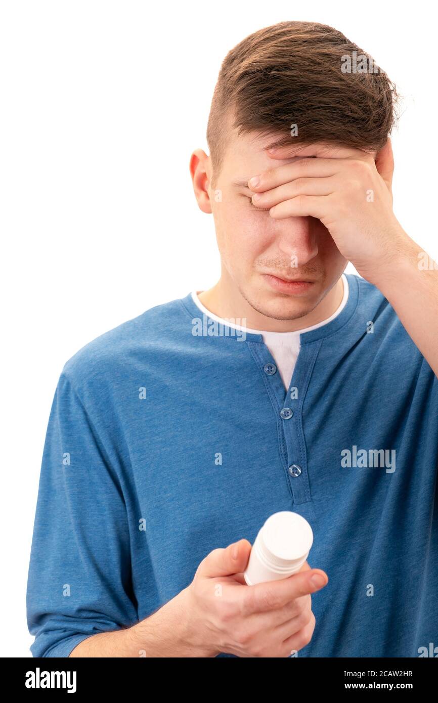 Young Man with the Bottle of the Medical Product feels Side Effect Isolated on the White Background Stock Photo