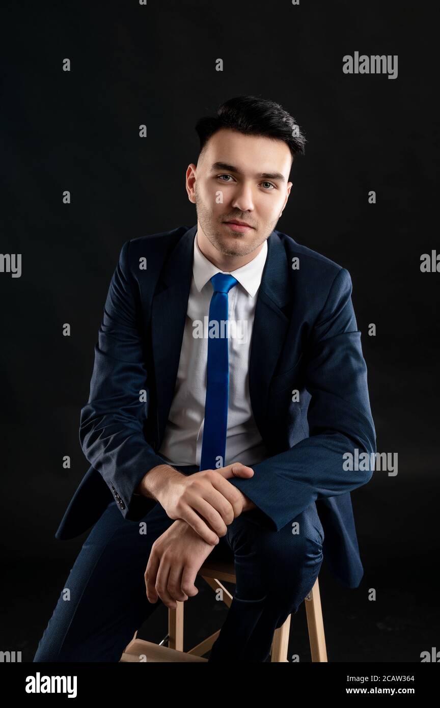 Portrait of business man wearing blue business suit and tie standing on ...