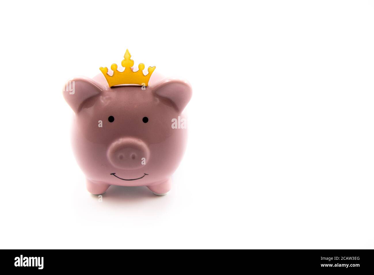 Pink piggy bank with golden crown isolated over white background with