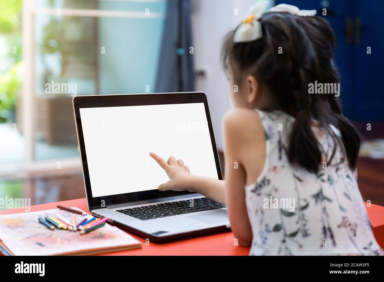 Asian girl elementary student using computer laptop for online learning ...