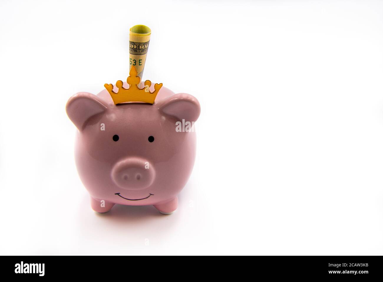 Pink piggy bank with golden crown and USD banknote isolated over white background with copy space, cash is king concept image Stock Photo