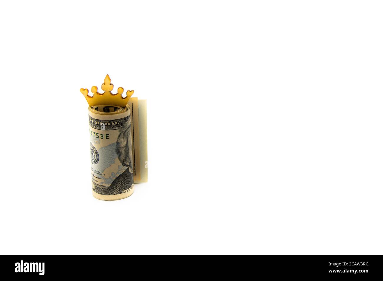 Stack of US dollars with golden crown isolated over white background with copy space, cash is king concept image Stock Photo