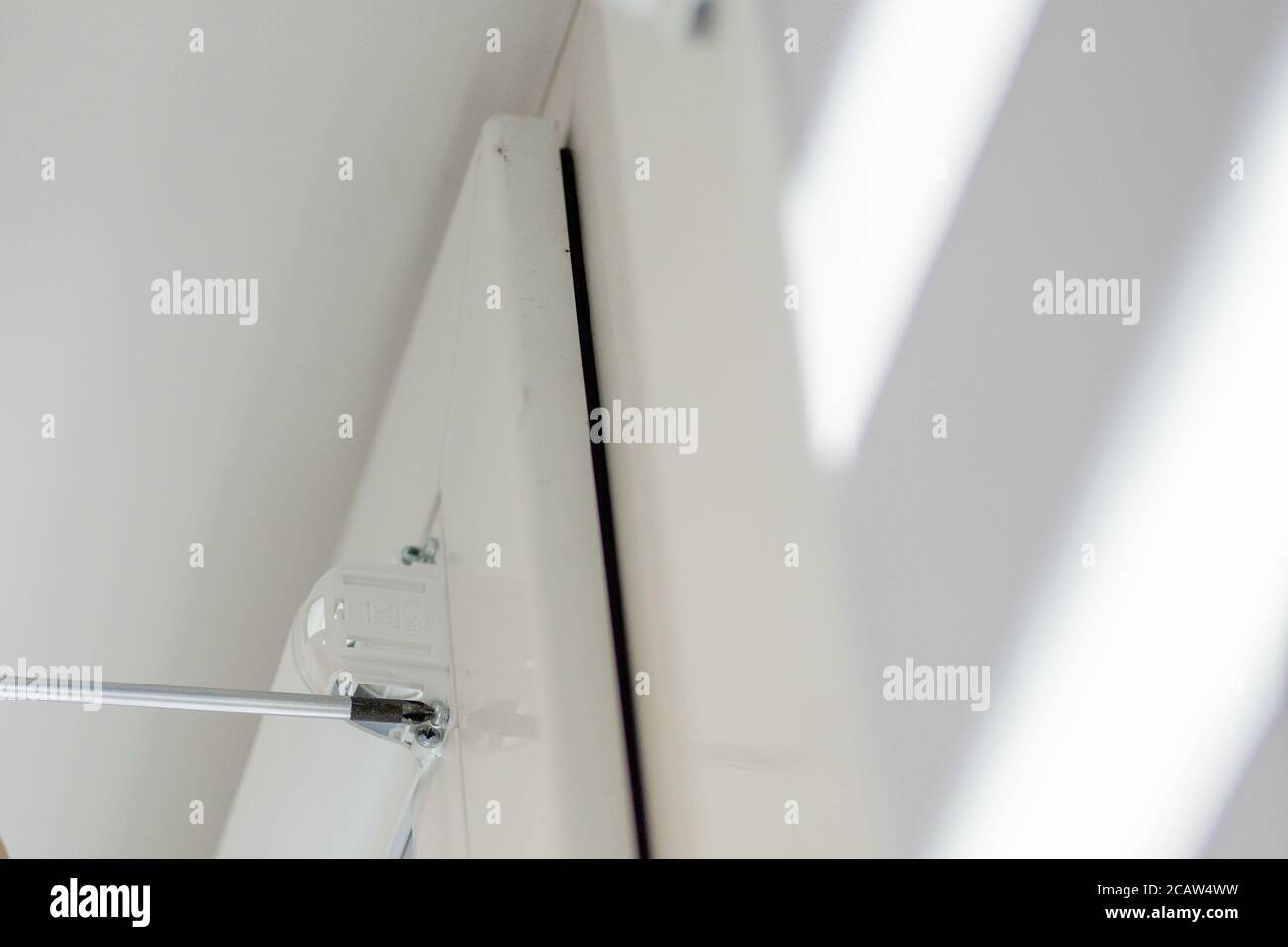 Man installing cassette roller blinds on windows Stock Photo Alamy