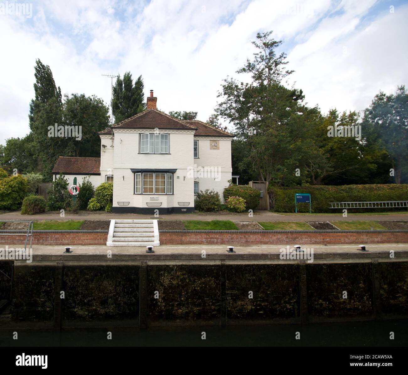 25 July 2020 - Marlow, UK: Canalside cottage with steps and gardens Stock Photo
