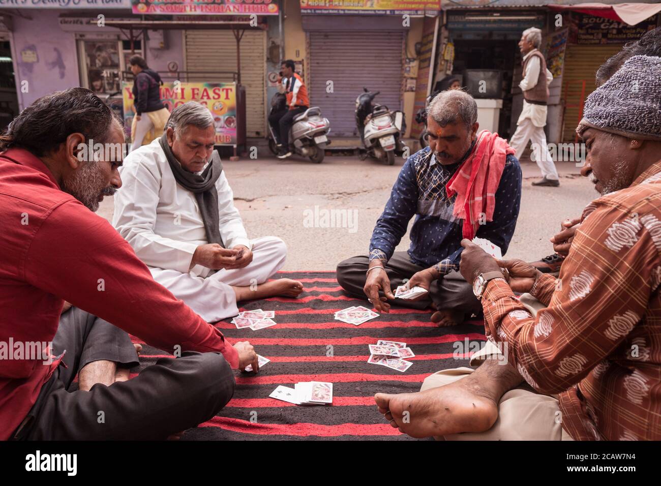 Pushkar / India - March 10, 2020: group of men playing cards on carpet on  the street floor in Pushkar Stock Photo - Alamy