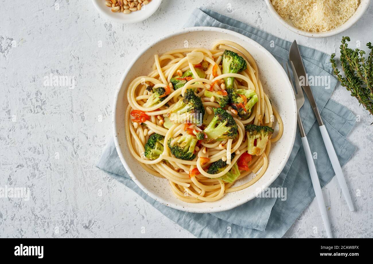 Spaghetti pasta with broccoli, bucatini with peppers, garlic, pine nuts. Food for vegans Stock Photo