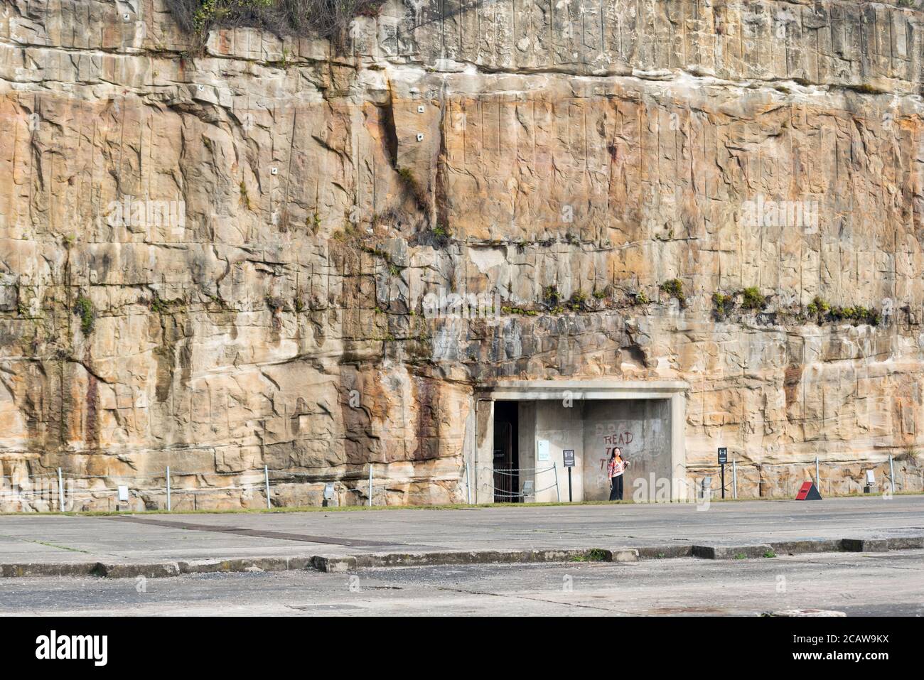 One of two long tunnels through the giant sandstone rock face, that connect to the other side of Cockatoo Island dockyard in Sydney Harbour, Australia Stock Photo