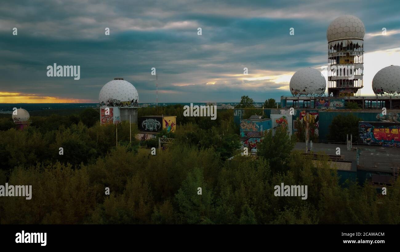 Drone view of the abandoned cold-war-era US listening station on Teufelsberg rubble hill in Grunewald forest at sunset. Stock Photo